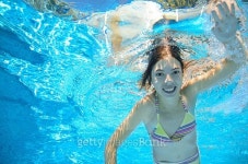 Happy child swims in pool underwater, active kid swimming... Happy child swims in pool underwater, active kid swimming