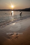 People bathing in sea at sunset on Elba island, Italy 이미지 (473747326) - 게티이미지뱅크 People bathing in sea at sunset on... 