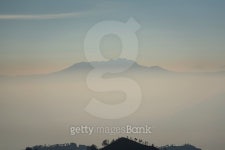 Foggy and volcano mountain during sunrise 이미지 (493059420) - 게티이미지뱅크 Foggy and volcano mountain during sunrise