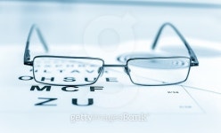 Clear Black modern glasses on a eye sight test chart 이미지... Clear Black modern glasses on a eye sight test chart
