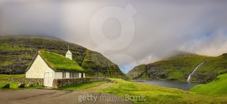 Village church and a lake in Saksun, Faroe Islands, Denmark... 게티이미지뱅크 Village church and a lake in Saksun, Faroe Islands... 