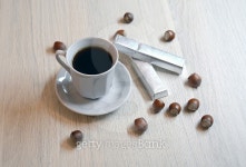 Cup of black coffee and two hazelnut chocolates with nuts... Cup of black coffee and two hazelnut chocolates with nuts