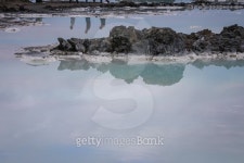 Three people reflected in Icelandic blue water 이미지 (503809636) - 게티이미지뱅크 Three people reflected in Icelandic blue water