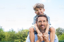 Father Giving Piggyback Ride stock photo 528286972 | iStock Happy father giving shoulder ride on his shoulders in garden. Happy...