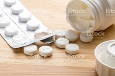 Pills And Pill Bottle On Wooden Background stock photo 504703970 | iStock Pills and open pill bottle on wooden background
