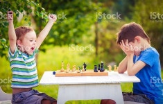Vivid Emotions After The Game Of Chess 스톡 사진 586945434 | iStock two young chess players outdoors. boy rejoices won a game... 