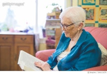 644111678 | 게티이미지코리아 | Beautiful elderly woman in apartment reading Bible Royalty-Free 이미지