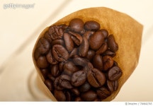 700842765 | 게티이미지코리아 | Close-Up Of Roasted Coffee Beans In Paper On Table Royalty-Free 이미지