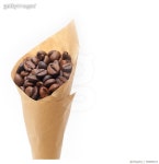 700859167 | 게티이미지코리아 | Close-Up Of Roasted Coffee Beans In Brown Paper Against White Background Royalty-Free 이미지