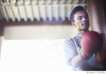 702540801 | 게티이미지코리아 | Young male boxer punching punch bag in gym Royalty-Free 이미지