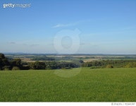 702641097 | 게티이미지코리아 | Scenic View Of Green Landscape Against Blue Sky Royalty-Free 이미지