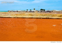 705170393 | 게티이미지코리아 | Orange Salt Basin By Village Against Blue Sky Royalty-Free 이미지