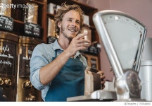 707448847 | 게티이미지코리아 | Coffee roaster weighing coffee in his shop Royalty-Free 이미지