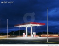 713768657 | 게티이미지코리아 | Empty floodlit gas station at night, Hof, Iceland Royalty-Free 이미지