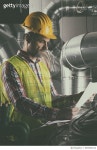 665950192 | 게티이미지코리아 | HVAC Engineer looking at blueprint Royalty-Free 이미지