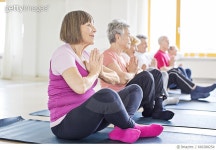 666388254 | 게티이미지코리아 | Senior woman exercising with friends at yoga class Royalty-Free 이미지
