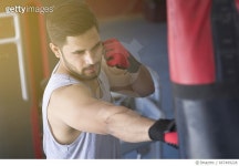 667499228 | 게티이미지코리아 | Boxer striking the punching bag at gym Royalty-Free 이미지