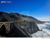 717241017 | 게티이미지코리아 | Bixby Creek Bridge At Rocky Mountains By Sea Against Blue Sky Royalty-Free 이미지
