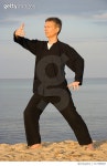 717386867 | 게티이미지코리아 | Man Practicing Tai Chi At Beach Against Sky Royalty-Free 이미지