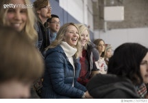 713775213 | 게티이미지코리아 | Smiling mothers watching ice hockey game in stadium bleachers Royalty-Free 이미지