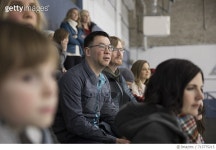 713775215 | 게티이미지코리아 | Focused fathers watching ice hockey game in stadium bleachers Royalty-Free 이미지
