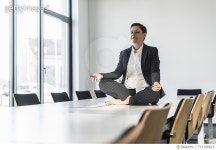 717168615 | 게티이미지코리아 | Businesswoman sitting on conference table meditating Royalty-Free 이미지