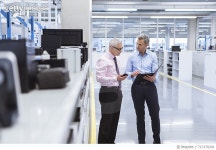 717170201 | 게티이미지코리아 | Two mangers discussing on shop floor of company Royalty-Free 이미지