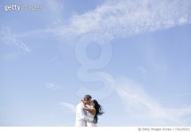 724229319 | 게티이미지코리아 | Romantic couple kissing against vast blue sky Royalty-Free 이미지