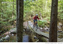 726772253 | 게티이미지코리아 | Mountain biker crossing a log bridge Royalty-Free 이미지