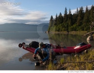 728922065 | 게티이미지코리아 | Man Filling Water In Container While Crouching By Boat At Lakeshore Against Trees Royalty-Free... 