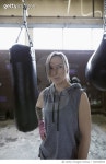 728760653 | 게티이미지코리아 | Portrait confident female boxer at punching bags in gym Royalty-Free 이미지