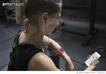 728761227 | 게티이미지코리아 | Woman weightlifting, resting and listening to music with headphones and mp3 player at gym Royalty... 