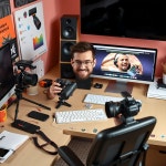 “Content creator at colorful desk with camera and editing tools, lifestyle setup” - AI 이미지 생성기 프롬프트