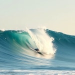 A surfboard is riding on top of the wave. Clear sky, natural lighting, soft shadows, photorealistic style, no man on surboard - AI... 
