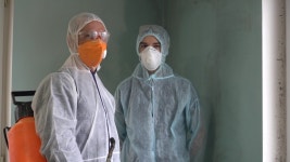 Sanitation worker sanitizing entrance gate of an office amid coronavirus pandemic Healthcare Videos | Creative Market Sanitation... 