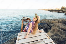 Young hipster woman sitting on wooden pier, Relaxing lying leg down to the lake. 5207493 Stock Photo at Vecteezy Download Young... 