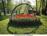 Beautiful flowerbed. Beautiful red tulips flowerbed in the shape of basket. | CanStock