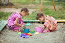 Two girls play in the sandbox at the ... | Stock image | Colourbox