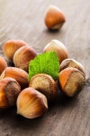 Hazelnuts with shell and green leaf on ... | Stock image | Colourbox