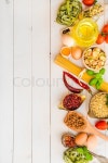 Uncooked pasta and spices on a white ... | Stock image | Colourbox