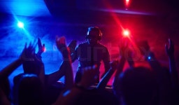 Modern deejay firing up dancing crowd ... | Stock image | Colourbox