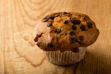 Fresh chocolate chip muffin on wooden ... | Stock image | Colourbox
