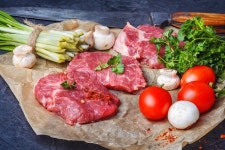 Sliced raw veal steaks with ramson and ... | Stock image | Colourbox