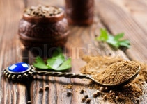 Coriandr and metal mill on a table | Stock image | Colourbox