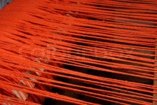 Thic red theads strained in the loom | Stock image | Colourbox