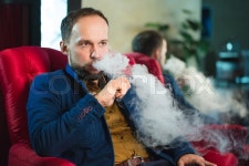 Smoking hookah. Man is blowing smoke in ... | Stock image | Colourbox