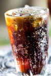 A glass of cola with ice cubes | Stock image | Colourbox