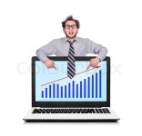 Happy businessman pointing to laptop ... | Stock image | Colourbox