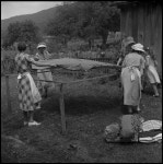 [Women setting down fabric] - UNT Digital Library [Women setting down fabric]