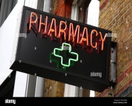 A neon pharmacy sign in a U.K. city Stock Photo - Alamy